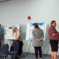 Guests looking at research posters.